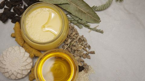 Flat lay of natural ingredients, herbs, and honey jars showcasing a healthy lifestyle and wellness theme.