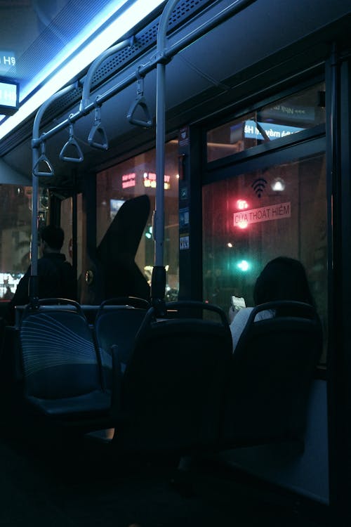 Night Photo of People in a Public Transport