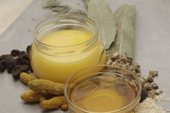Natural ingredients including bay leaves and oils arranged on a white background for culinary use.