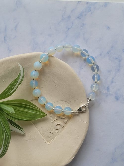 A bracelet with blue and white beads on it