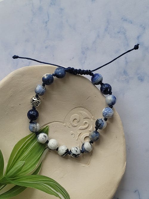A bracelet with blue and white beads on it