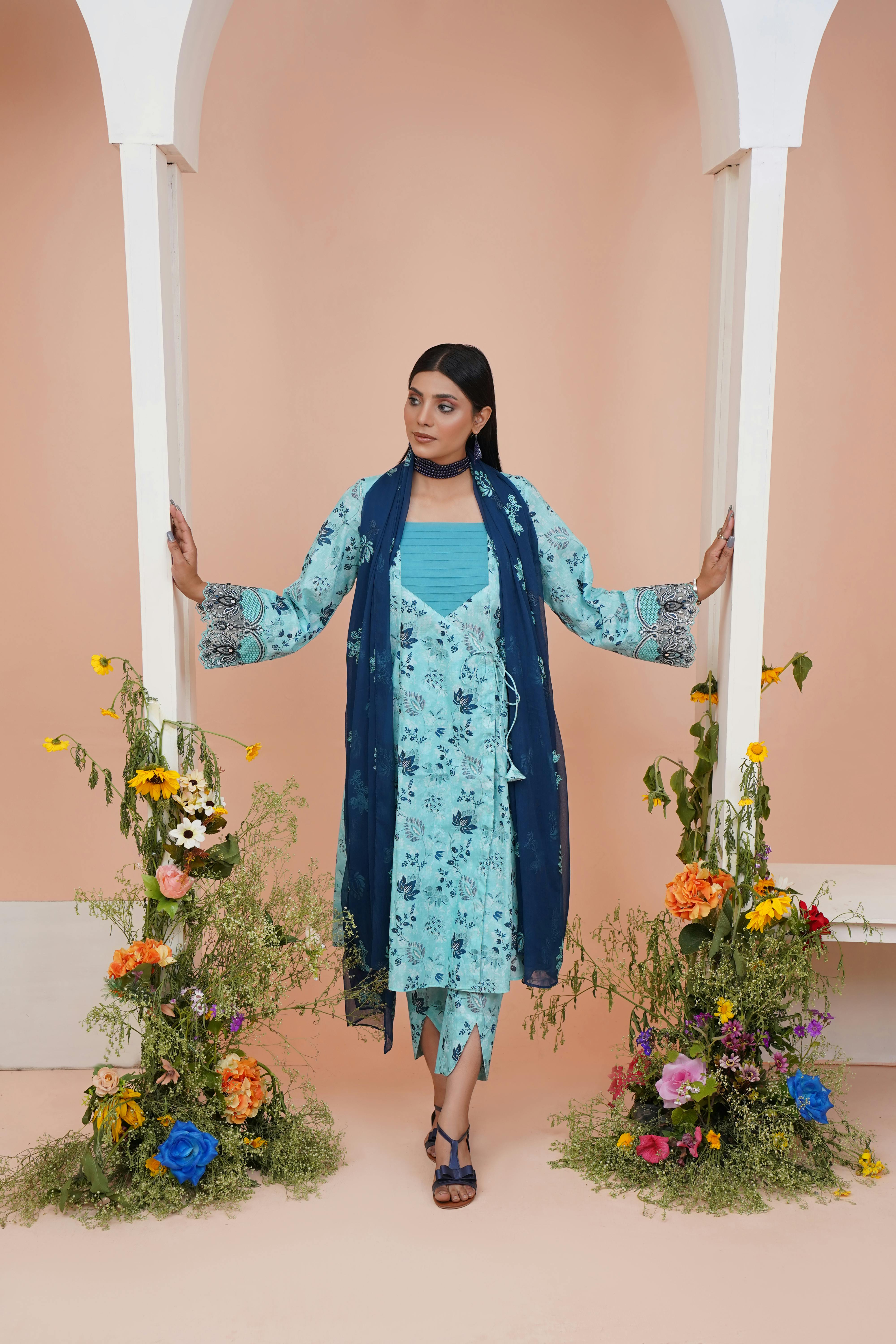 woman standing in blue traditional dress