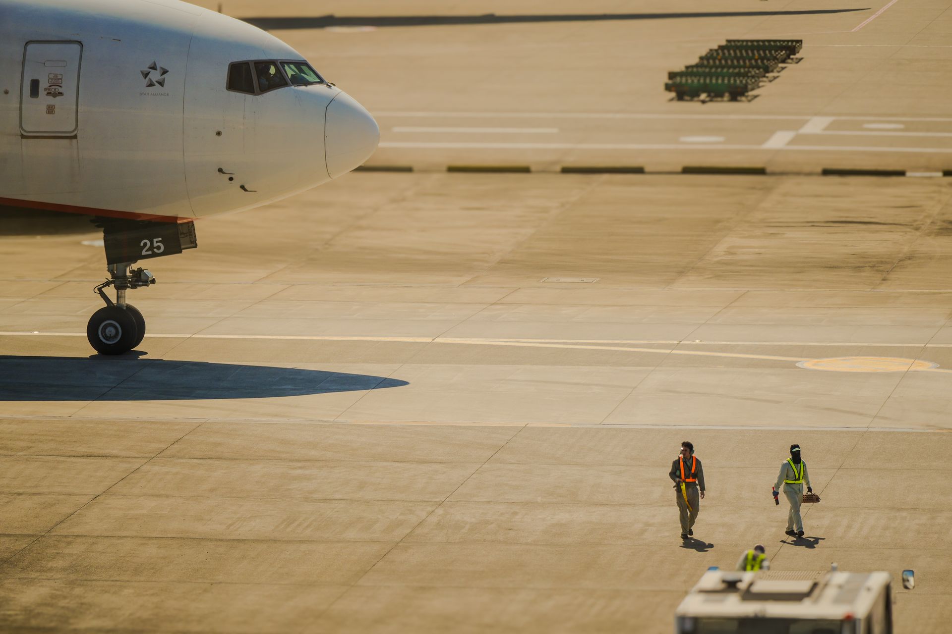 Airport Crew Walking on Runway by Jet