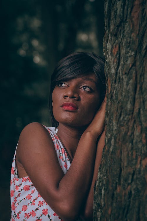 Woman Wearing White-and-pink Floral Sleeveless Shirt Near Tree