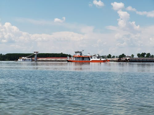 A boat is docked in the water near a dock