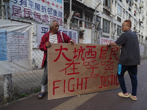 Free Two men holding a sign that says fight for justice Stock Photo