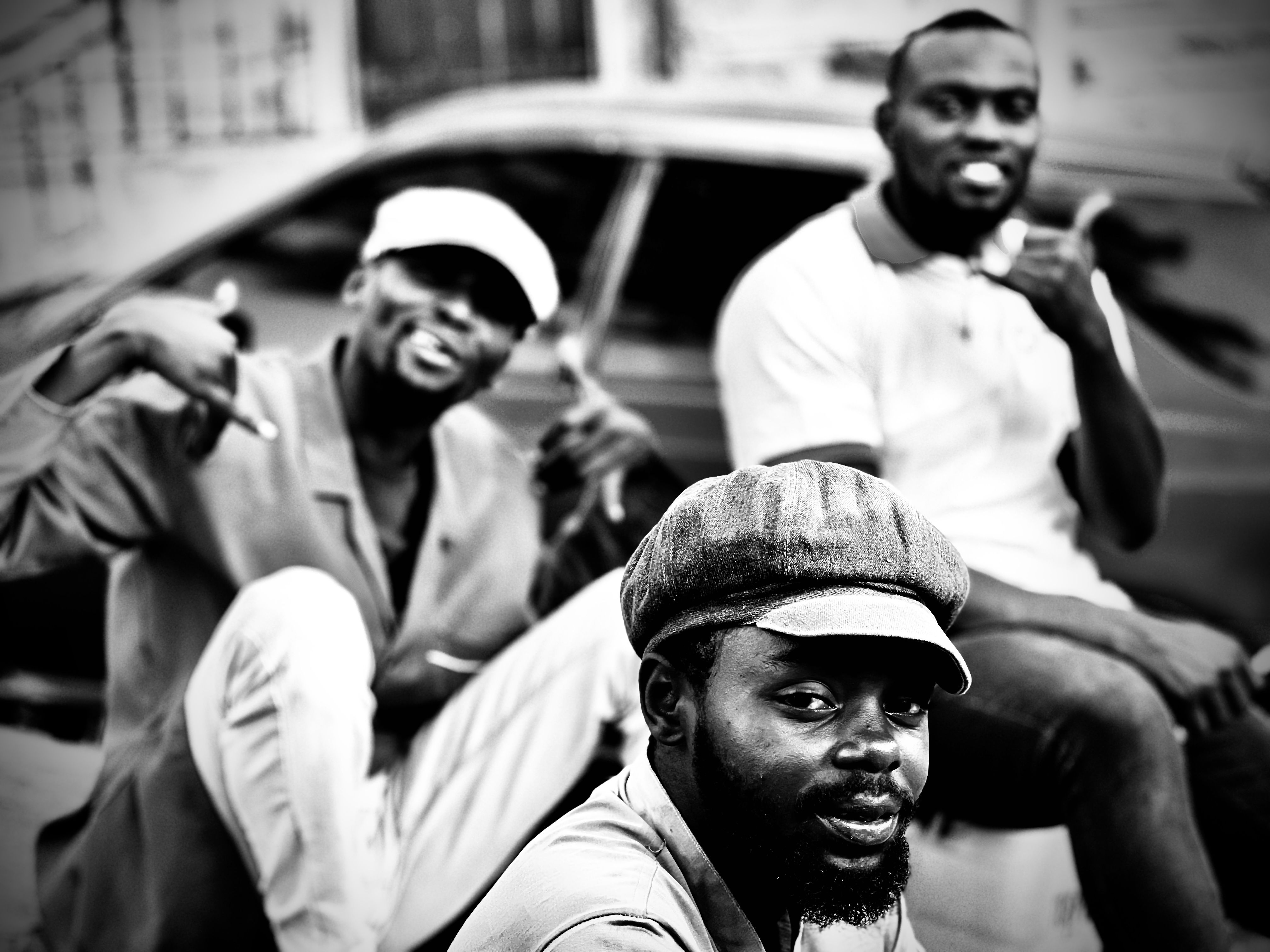 Black and White Photo of a Group of Men Sitting near a Car · Free Stock ...