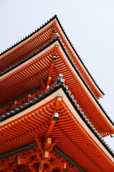Close-up of a vibrant traditional pagoda roof in Kyoto, showcasing intricate Japanese architecture.