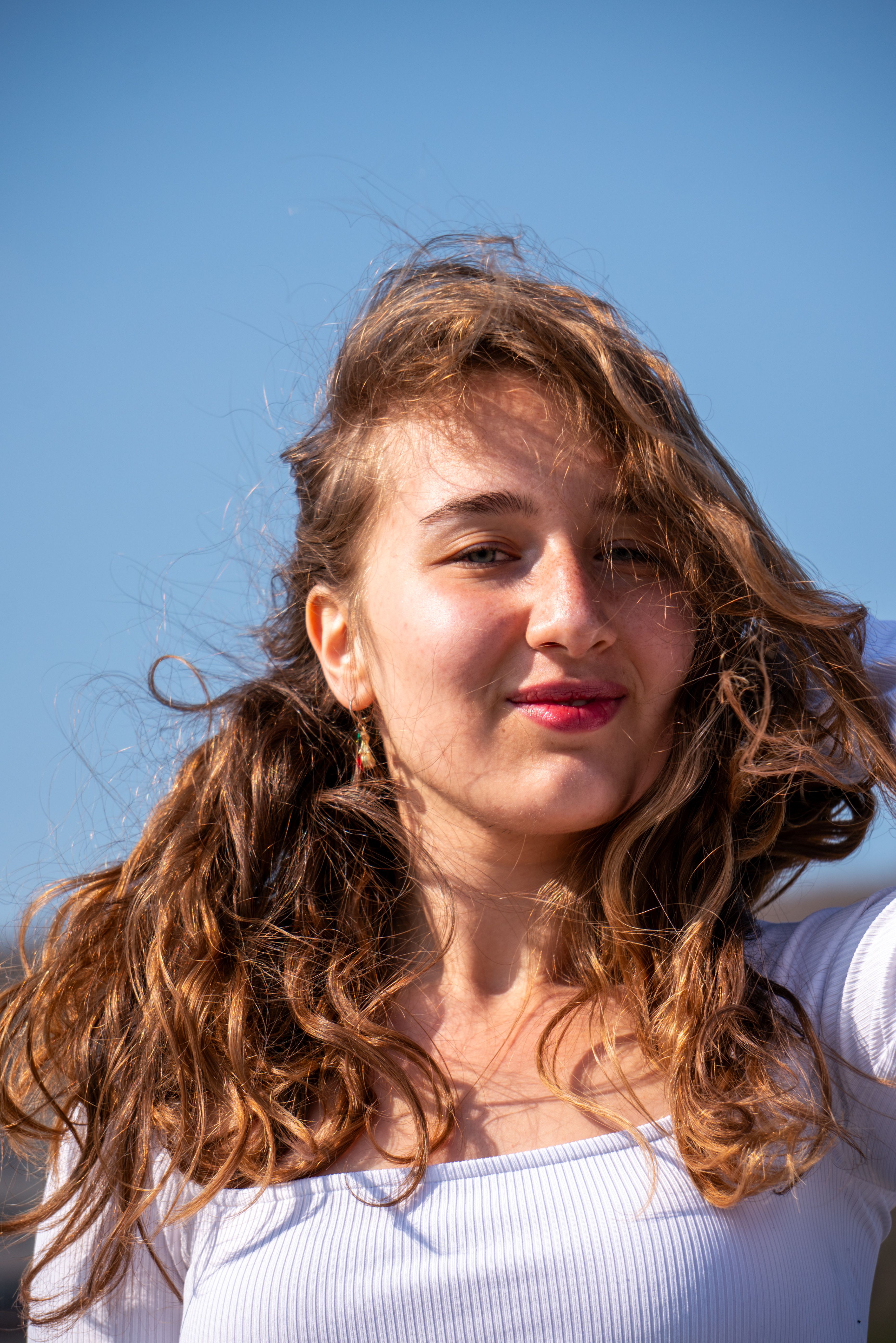 Smiling Woman with Wavy Hair · Free Stock Photo