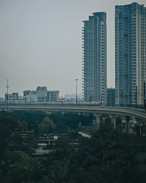 A view of a city with tall buildings and a bridge
