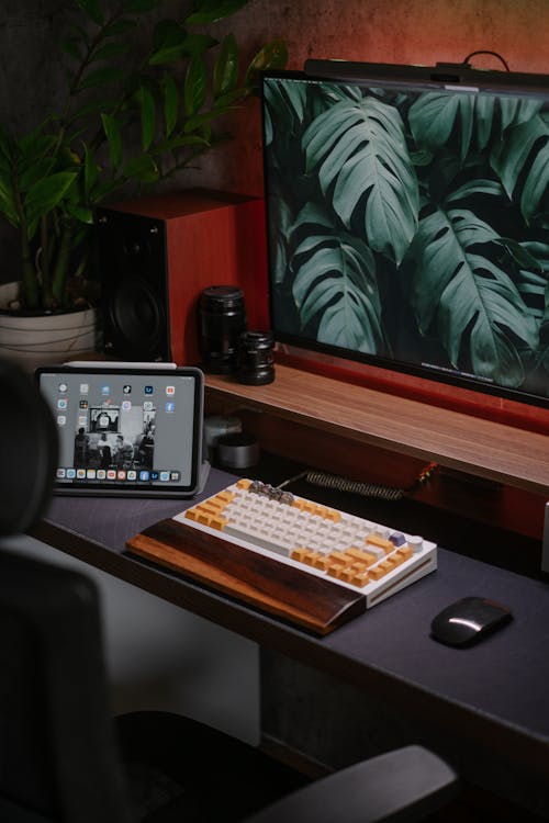 A desk with a computer and a tablet