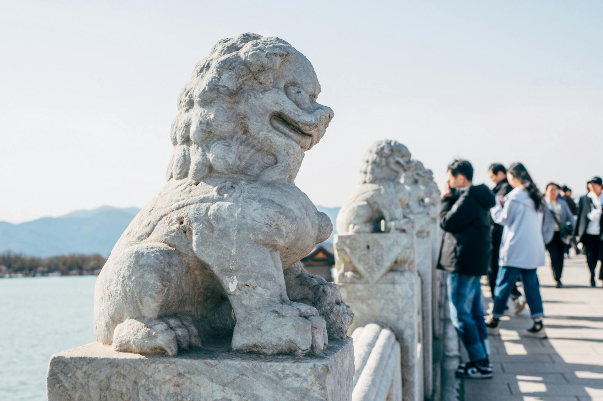 Tourists by Sculptures of Guardian Lions