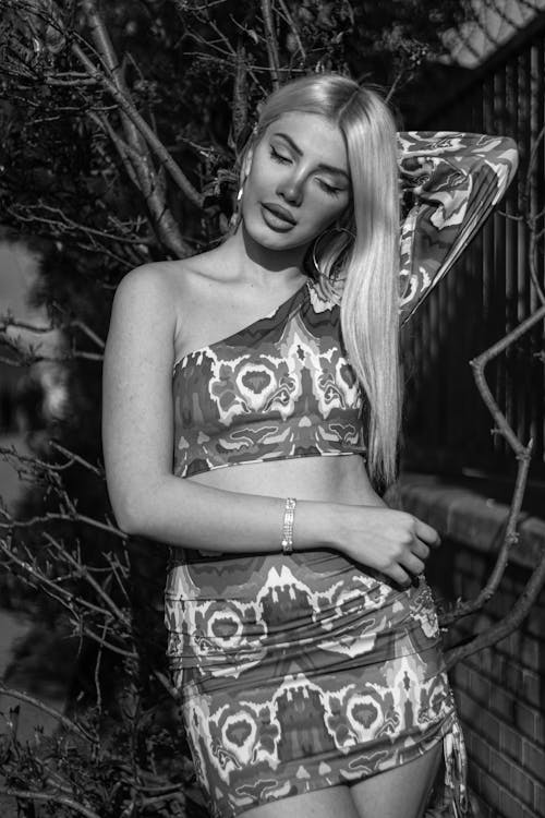 A black and white photo of a woman in a dress