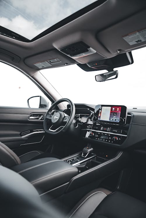 The interior of a car with a dashboard and steering wheel