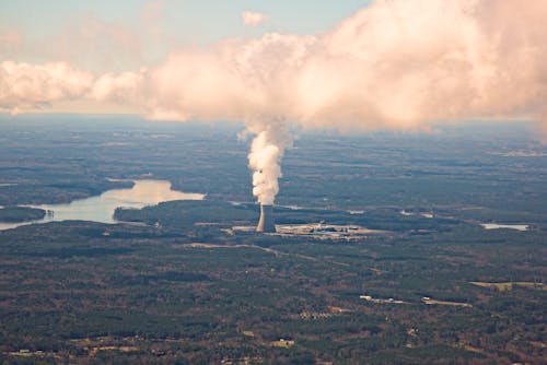 An aerial view of a coal plant with smoke coming out of it