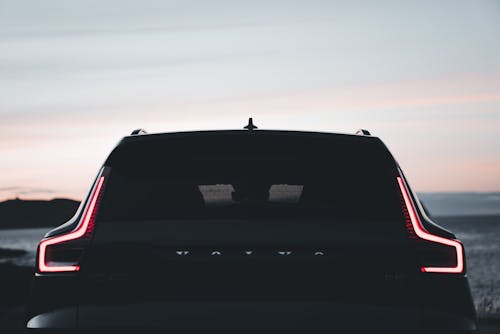 The rear end of a volvo car at sunset