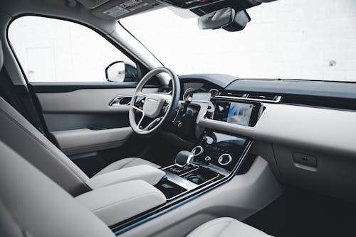 The interior of a car with leather seats and a steering wheel