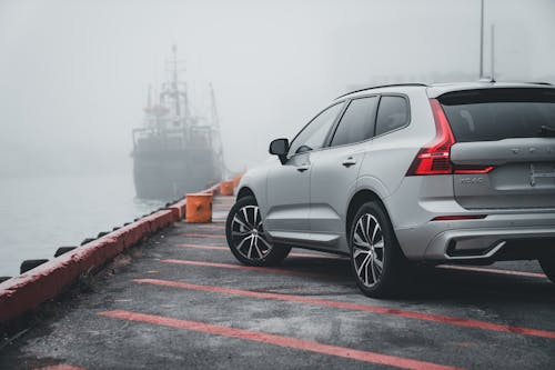 Volvo xc40 on the dock with a boat in the background
