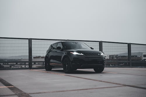 A black suv parked on a bridge