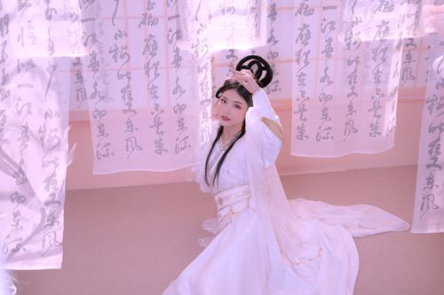 Free Elegant young woman in traditional Asian dress posing gracefully indoors. Stock Photo