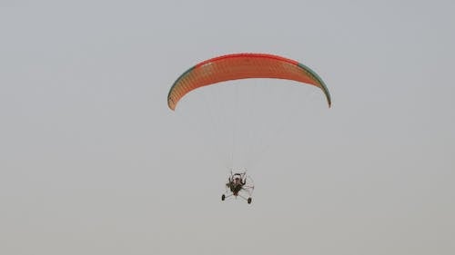 A paraglider is flying in the sky