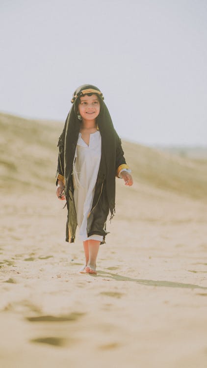 Little Girl with Headscarf Walking on Beach