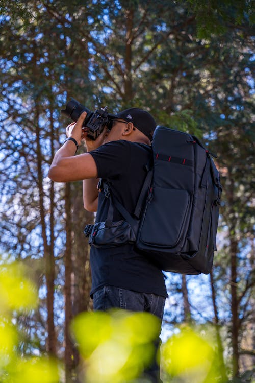 A man with a camera in the woods