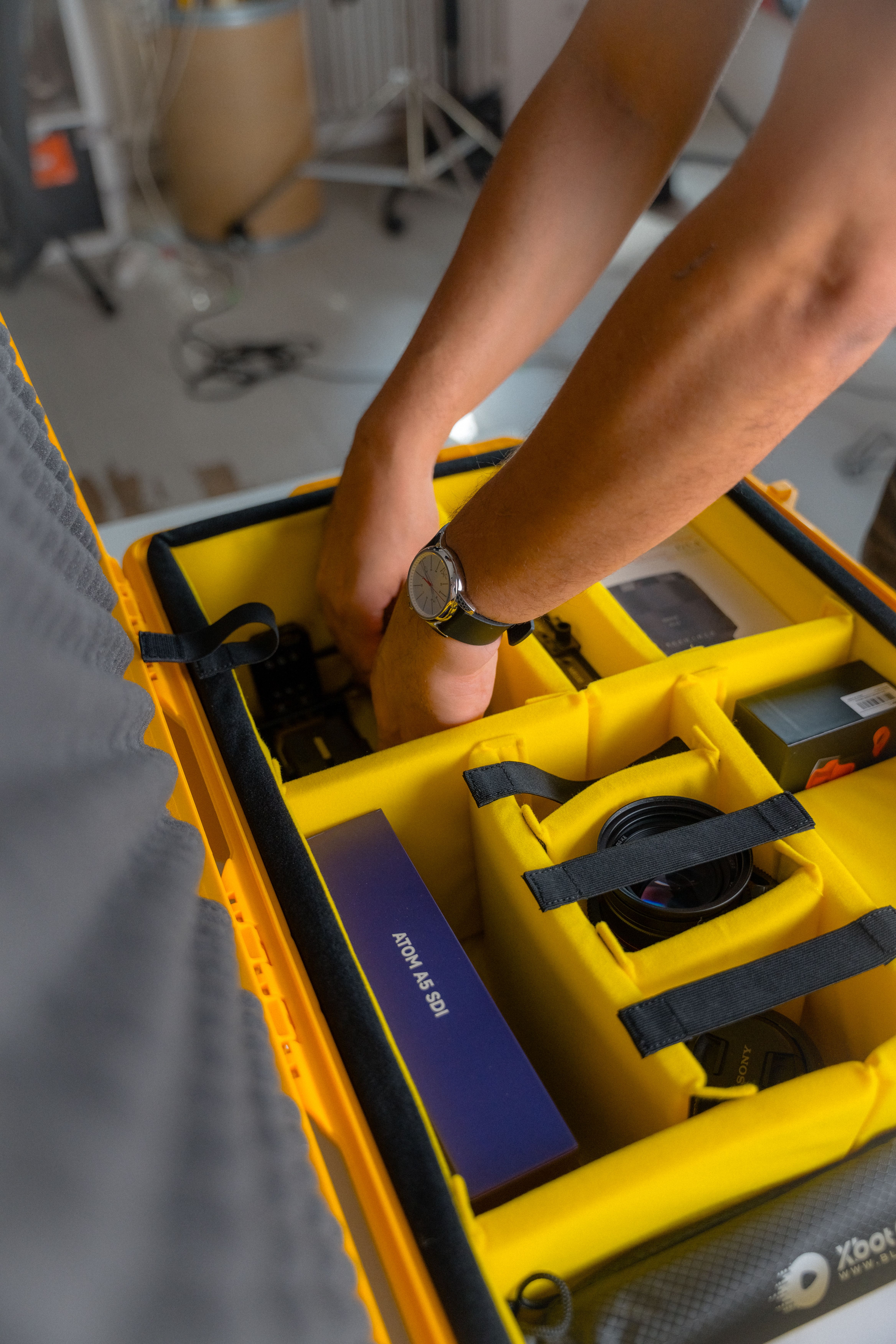 Hands Putting Items in Yellow Box · Free Stock Photo