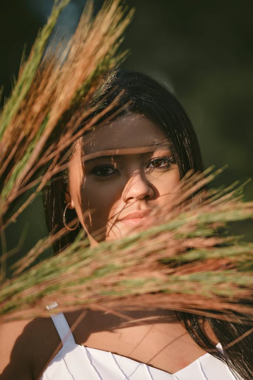 Portrait of Woman behind Grasses