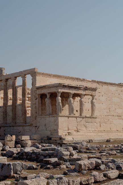 Detailed view of the Caryatids on the Erechtheion at the Acropolis in Athens, showcasing ancient Greek architecture.