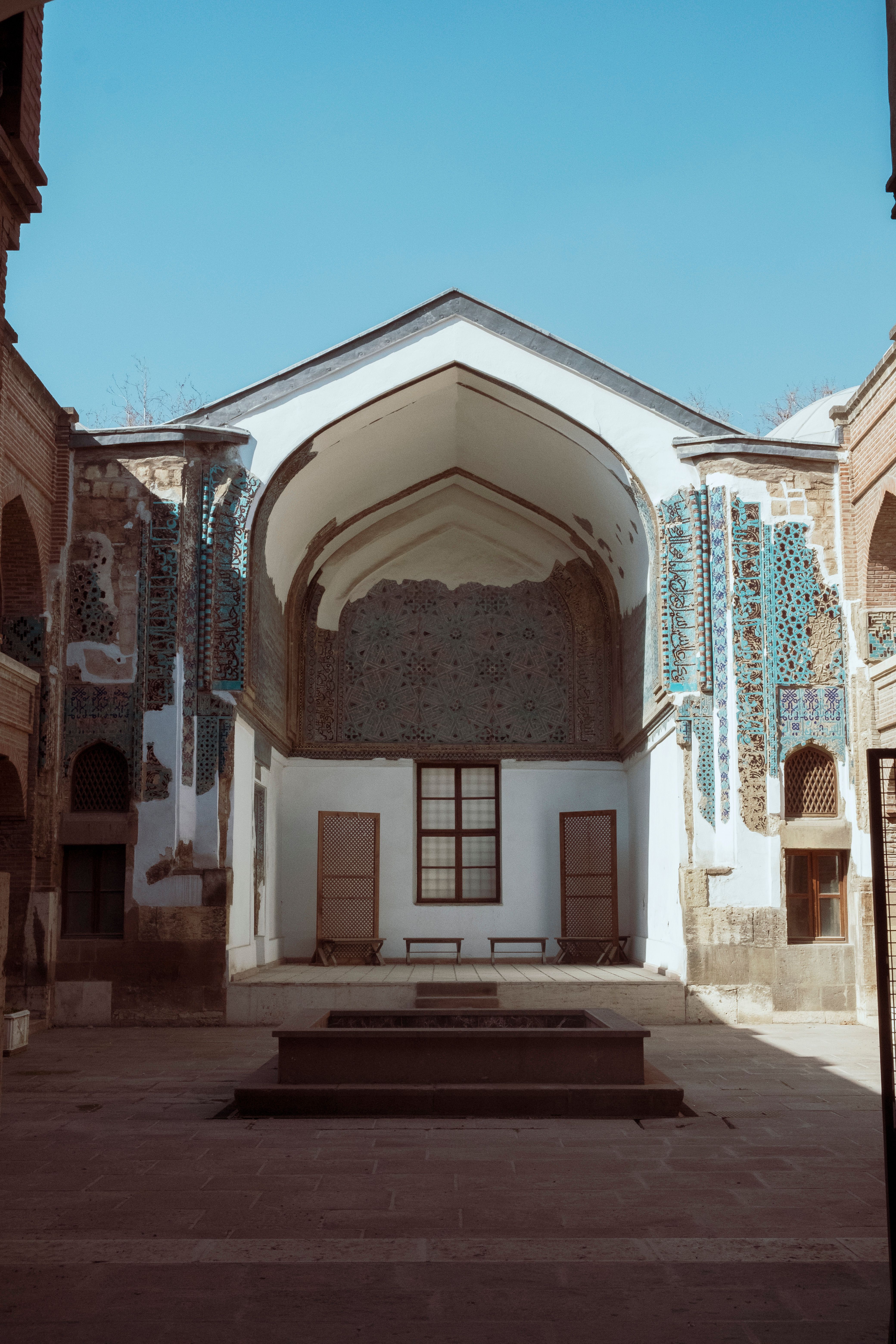 Beautiful architecture of Sircali Medrese under clear blue skies in Konya, Turkey.