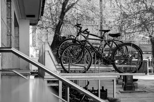 A black and white photo of two bicycles