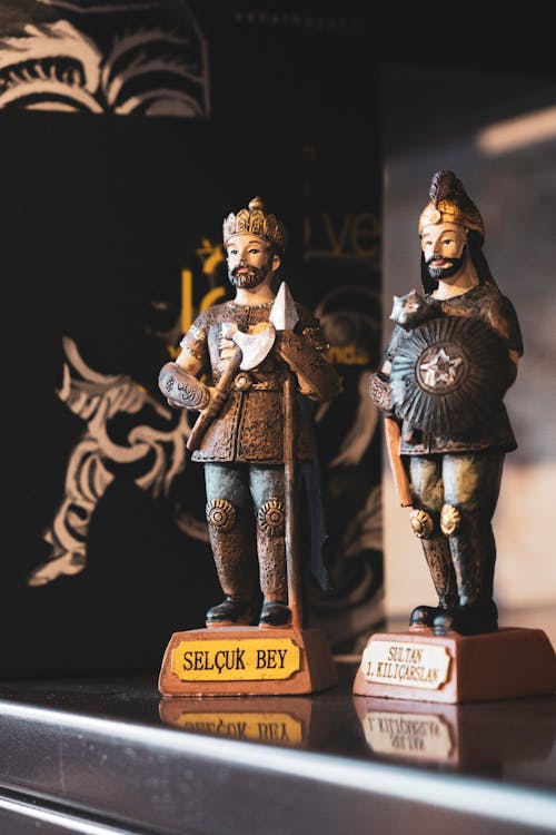 Two figurines of men in armor on a shelf