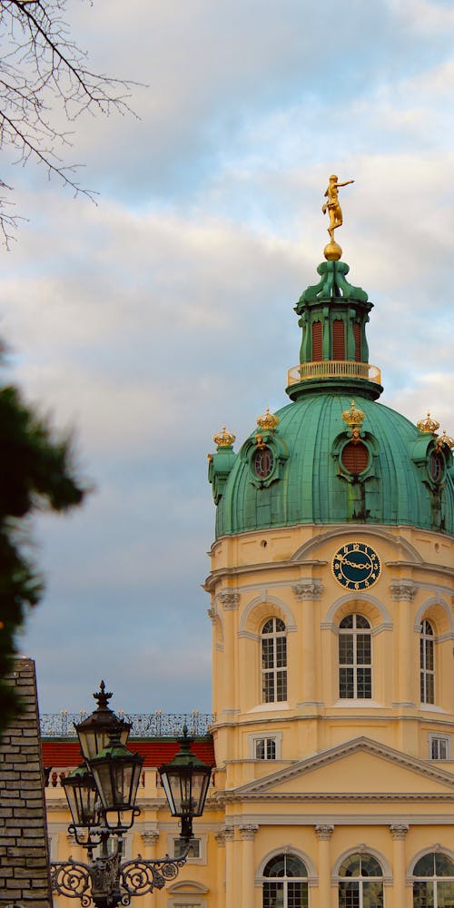 A church with a green dome and a clock