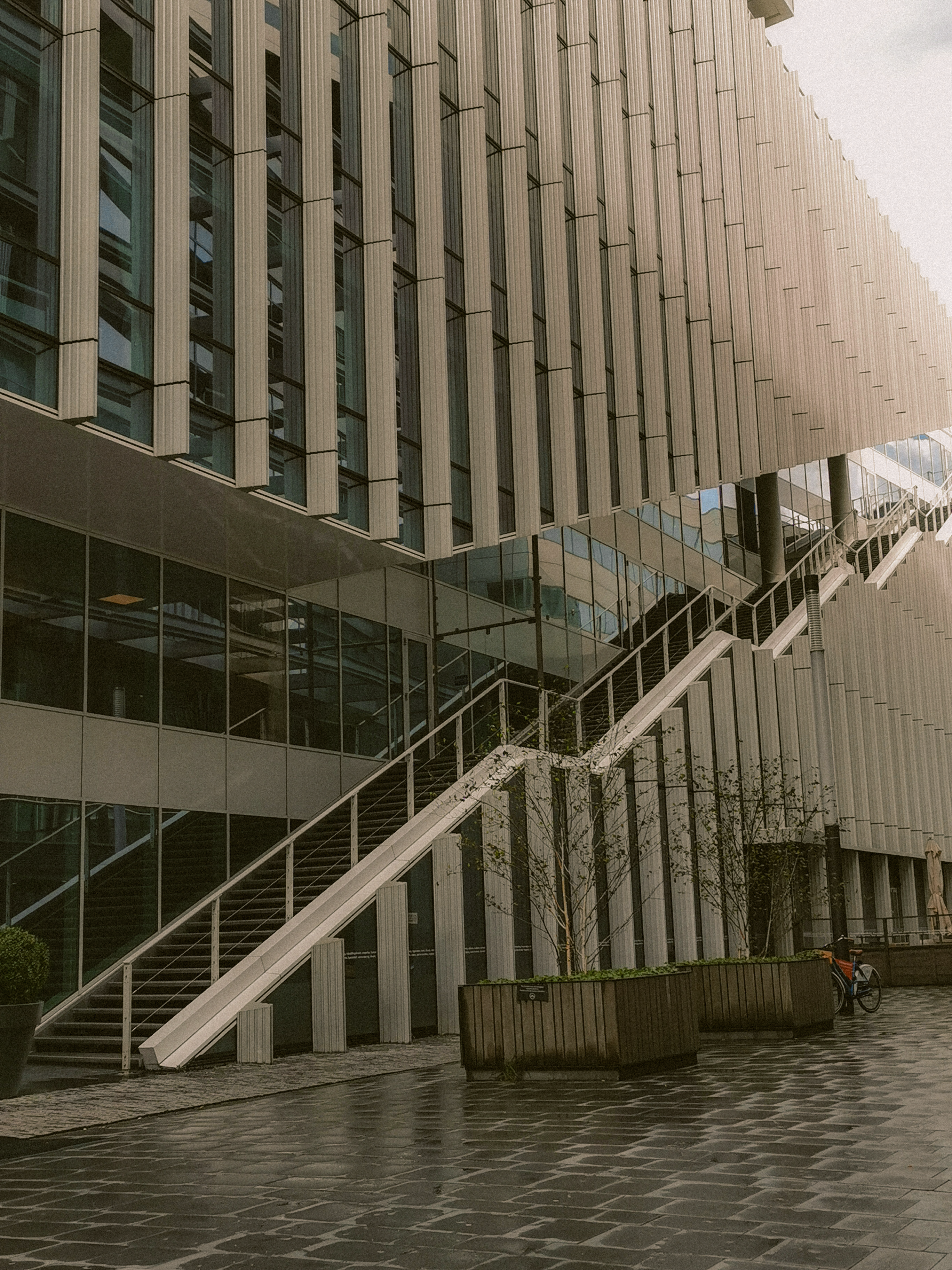 Explore the sleek futuristic design of a modern urban office building in the Netherlands.
