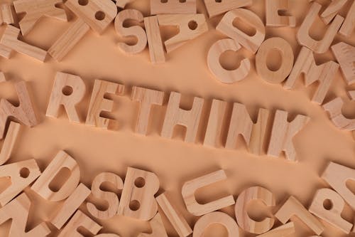 Rethink is a word surrounded by wooden letters
