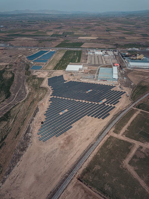 An aerial view of a solar farm in the middle of a field