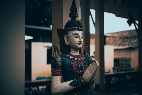 Free Intricately carved Hindu statue depicting a deity in prayer with detailed ornaments. Stock Photo