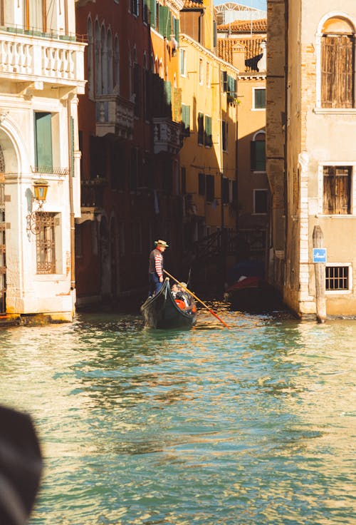 A gondola is floating down a canal in venice