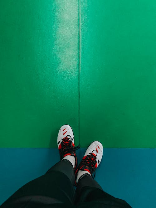 Free Person Wearing White and Red Sneakers Stock Photo