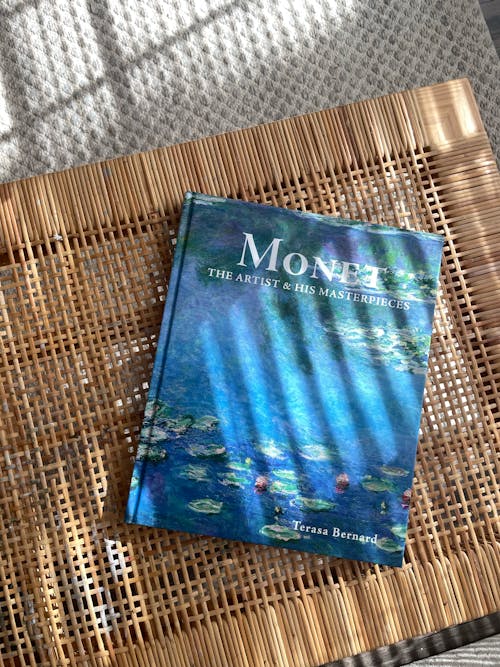 The book monet by claude monet is on a table
