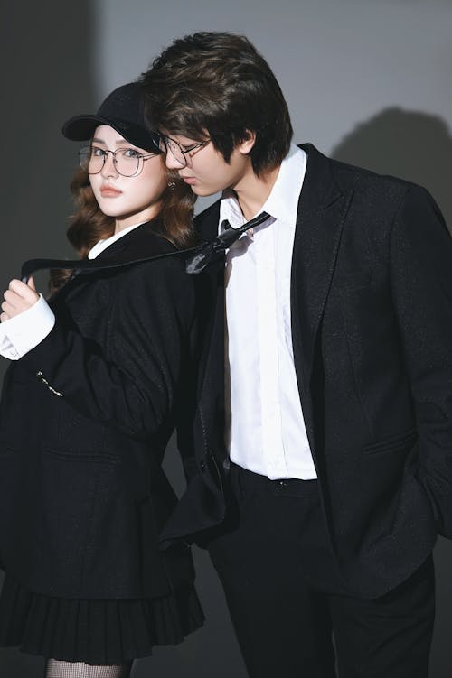 A man and woman in suits and glasses