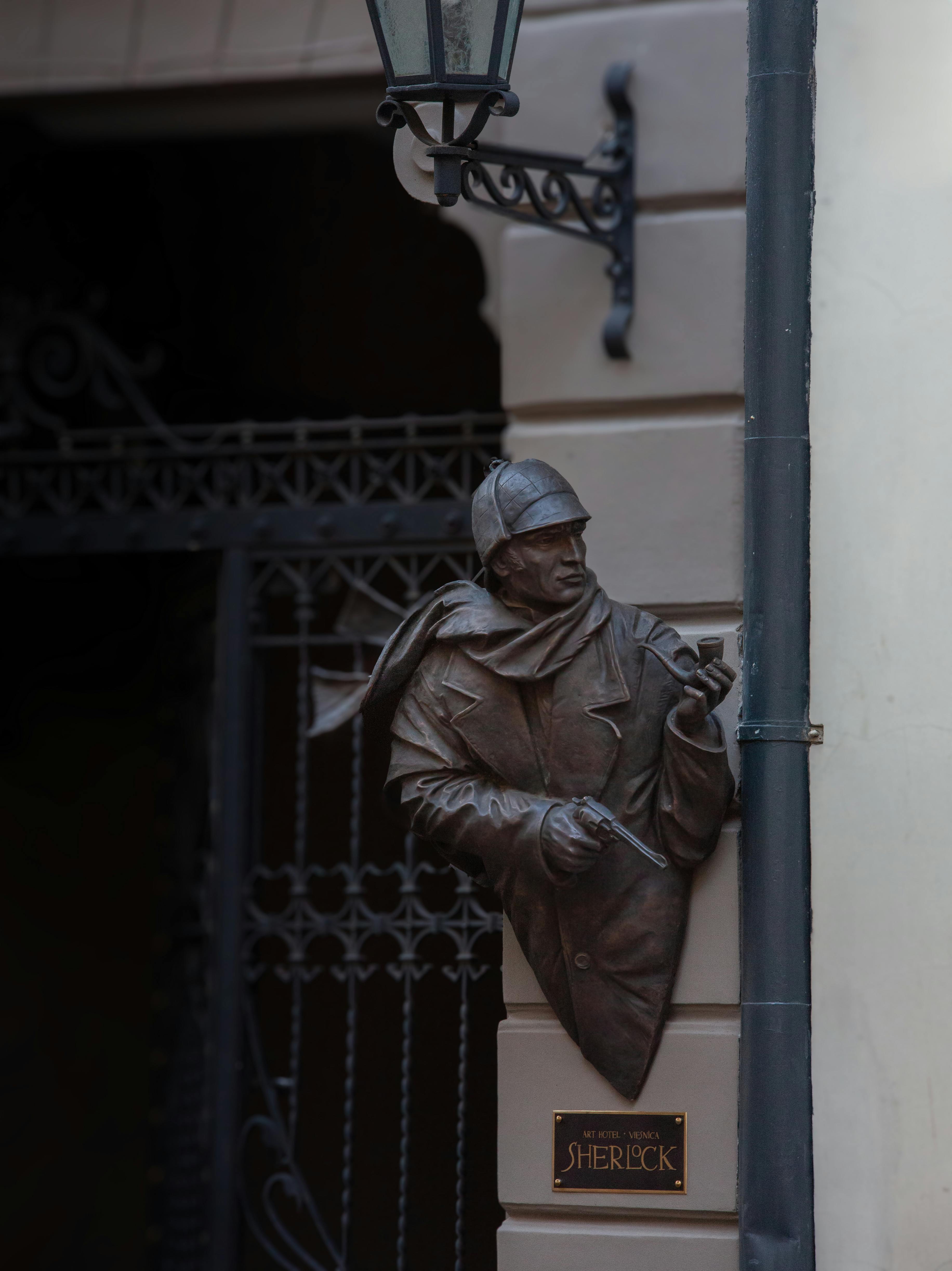 A statue of Sherlock Holmes attached to a building. 