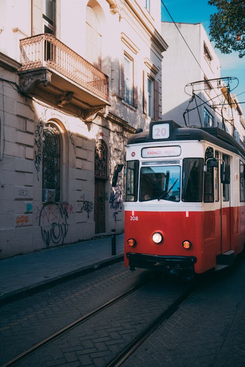 A red and white tram on the street