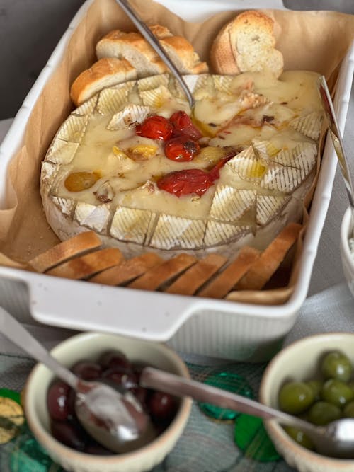 A tray with cheese, olives and bread