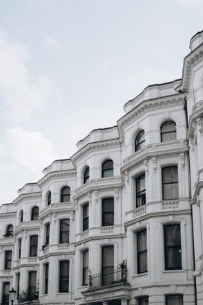 A row of white-fronted terraced town houses in London representing the high-value enveloped dwellings that fall within the ATED valuation cycle