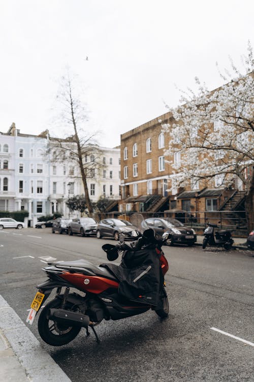 A motor scooter parked on the side of a street