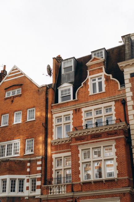 Elegant red brick residential buildings in London's urban landscape.