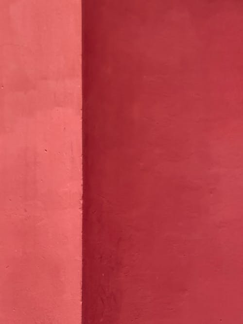 A red wall with a white stripe and a red door