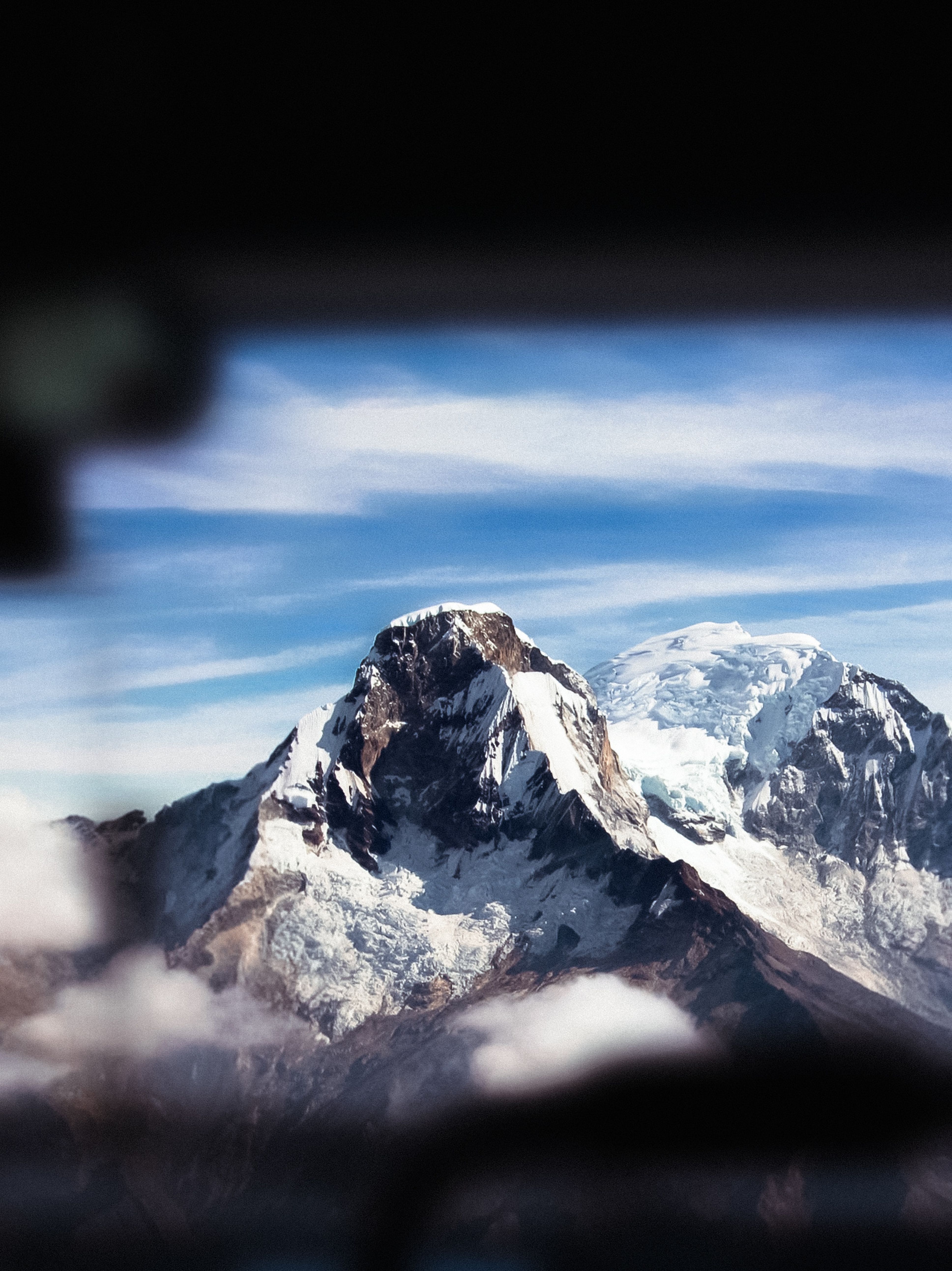 Stunning snow-capped mountain peak against a clear blue sky, offering a breathtaking view.